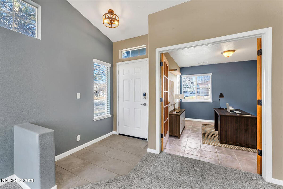 7663 La Ramba Drive Sparks, NV 89436 - Photo 3 of 27 a view of a hallway to livingroom with furniture and windows