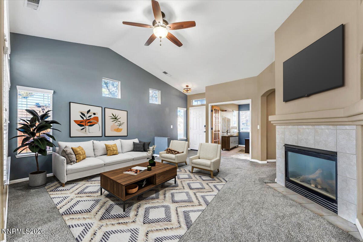 7663 La Ramba Drive Sparks, NV 89436 - Photo 6 of 27 a living room with furniture a fireplace and a flat screen tv