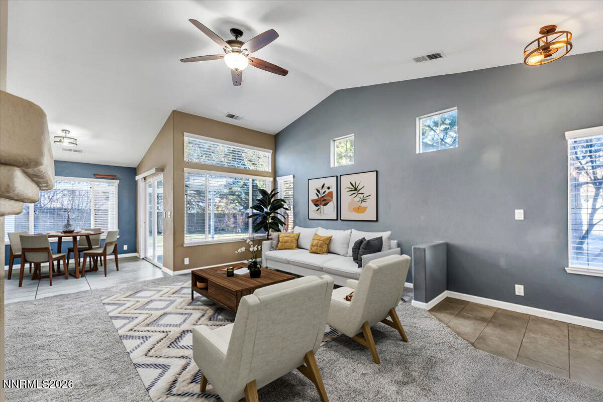 7663 La Ramba Drive Sparks, NV 89436 - Photo 7 of 27 a living room with furniture two window and a dining table