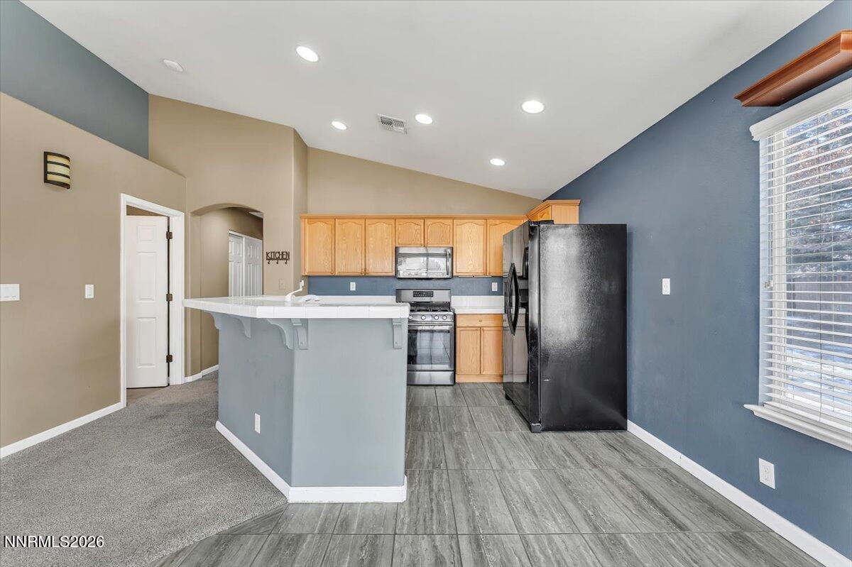 7663 La Ramba Drive Sparks, NV 89436 - Photo 9 of 27 a kitchen with stainless steel appliances a refrigerator sink and cabinets