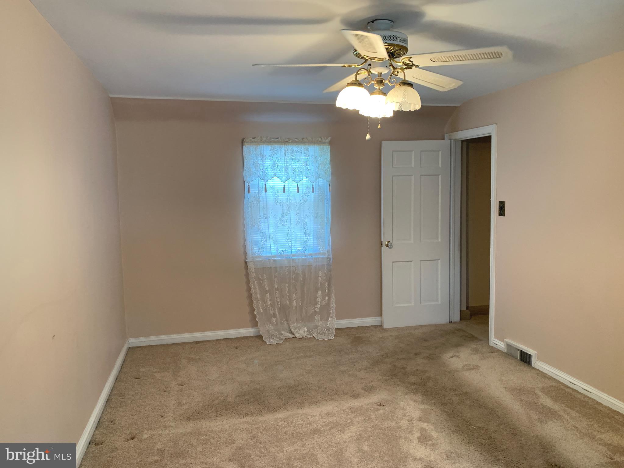 640 Laurel Road Springfield, PA 19064 - Photo 14 of 30 an empty room with windows and chandelier fan