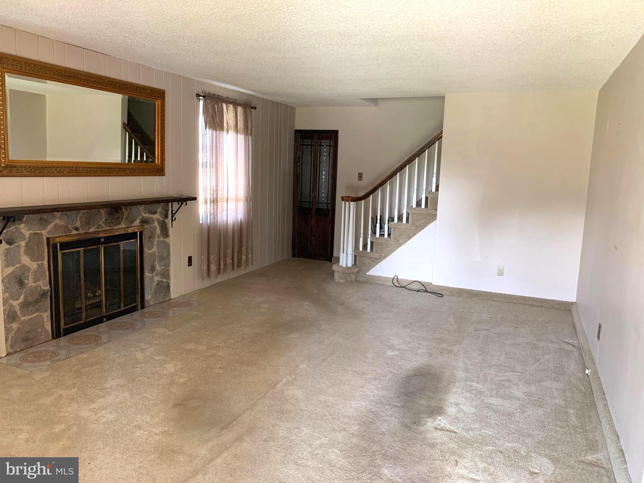 640 Laurel Road Springfield, PA 19064 - Photo 4 of 30 a view of an empty room with window and fireplace