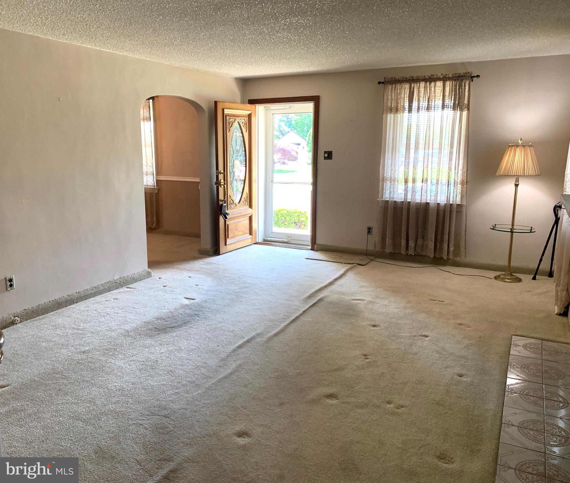640 Laurel Road Springfield, PA 19064 - Photo 6 of 30 an empty room with windows and refrigerator
