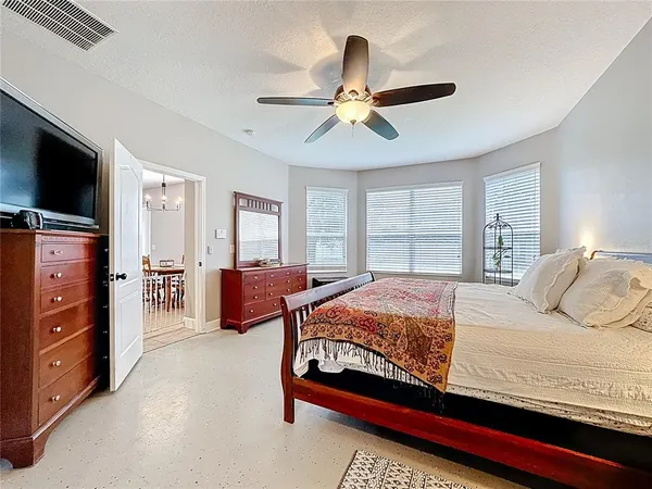 a bedroom with a bed dresser and a window