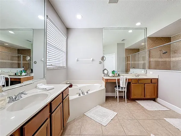 a bathroom with a tub sink and mirror