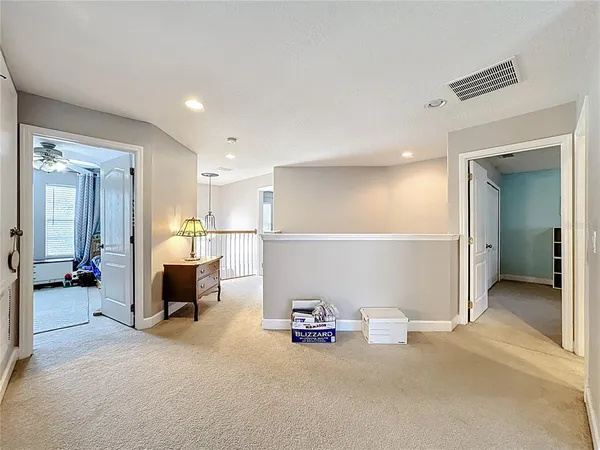 a view of a livingroom with furniture and a ceiling fan