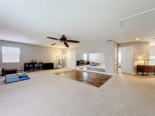 a spacious bedroom with a bed and a cabinets
