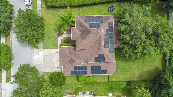 an aerial view of a house with a garden and swimming pool