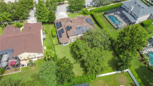 an aerial view of residential houses with outdoor space and street view
