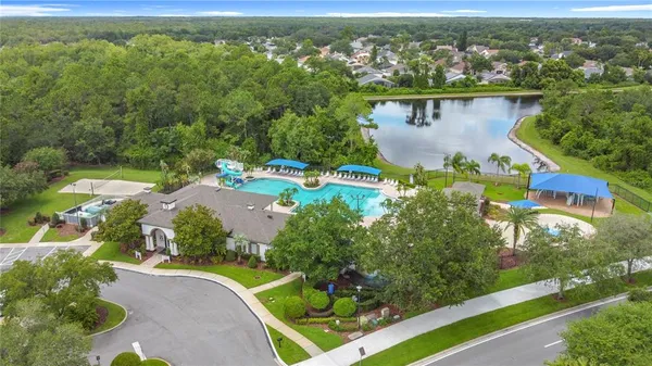 an aerial view of a house with a garden and lake view
