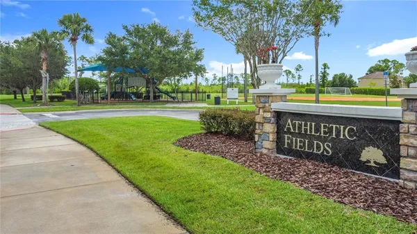 a view of a park that has a sign board