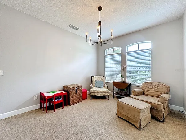 a bedroom with furniture and a chandelier