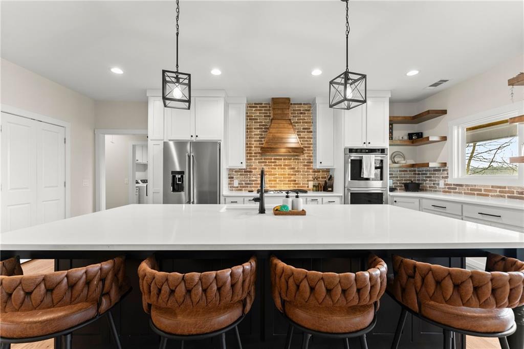 201 Fred Pitts Road Demorest, GA 30535 - Photo 20 of 55 a kitchen with granite countertop a table chairs a sink dishwasher a dining table and chairs