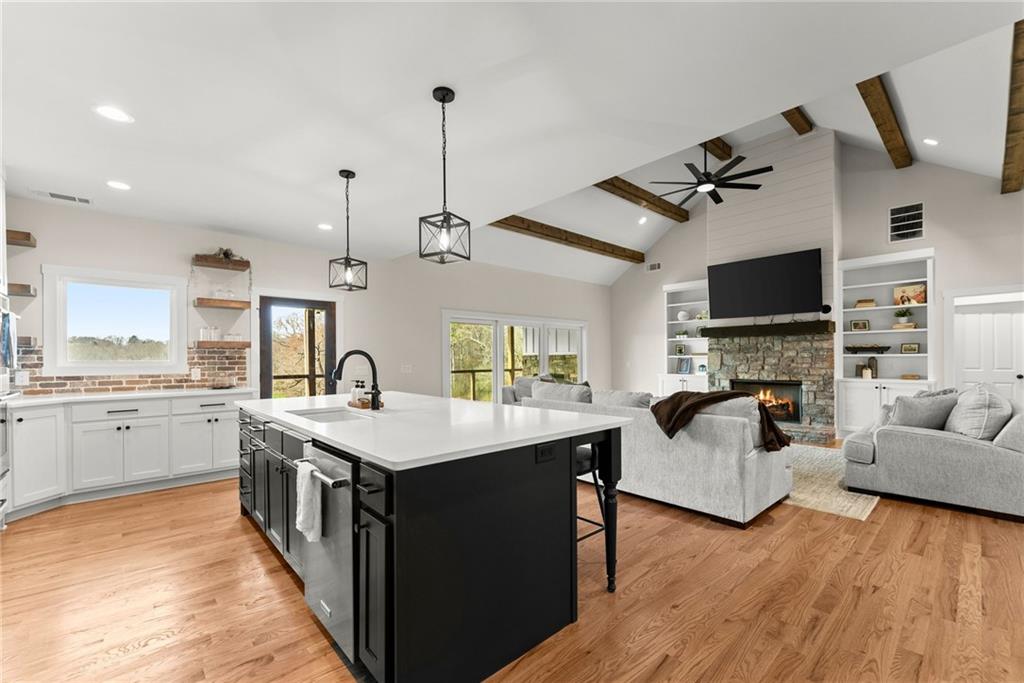 201 Fred Pitts Road Demorest, GA 30535 - Photo 21 of 55 a open kitchen with stainless steel appliances granite countertop a sink dishwasher and a fireplace with wooden floor