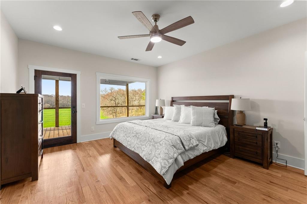 201 Fred Pitts Road Demorest, GA 30535 - Photo 24 of 55 a bedroom with a large bed and a large window