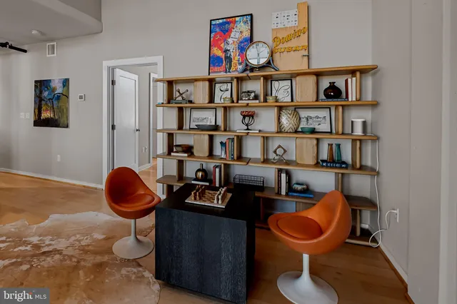 a dining room with furniture entryway and wooden floor