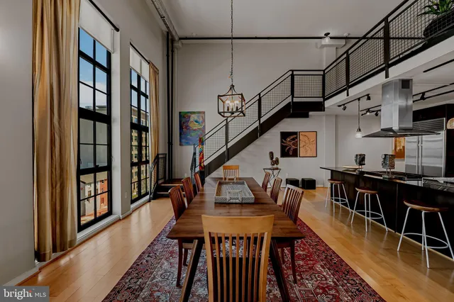a dining room with furniture and wooden floor