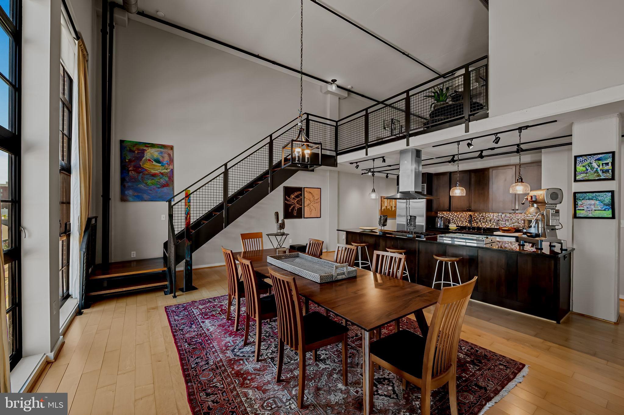 1220 Bank Street, Unit 407 Baltimore, MD 21202 - Photo 14 of 52 a dining room with furniture and wooden floor