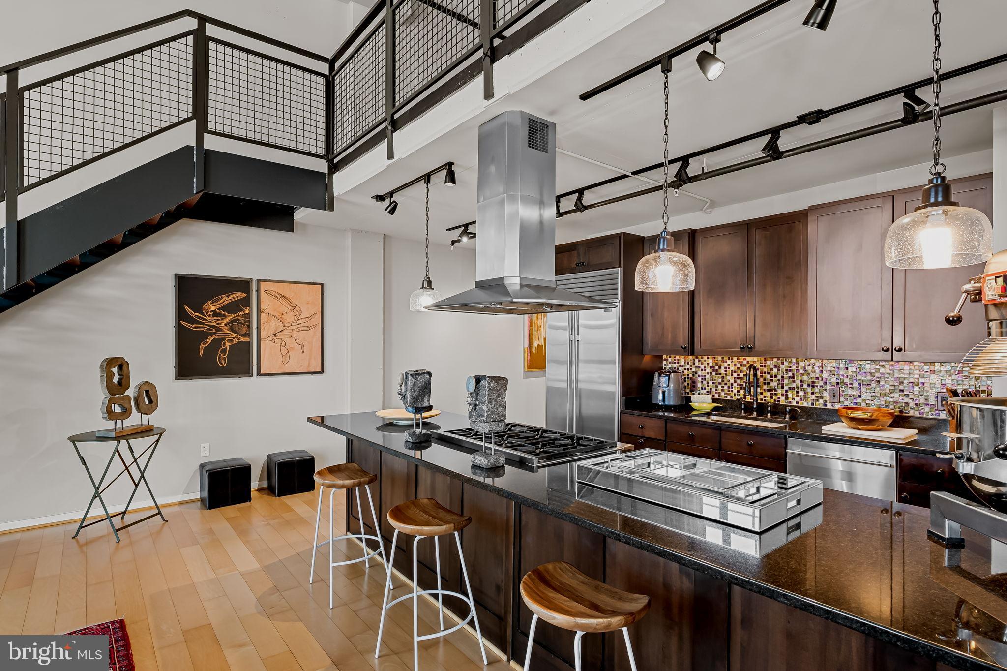 1220 Bank Street, Unit 407 Baltimore, MD 21202 - Photo 19 of 52 a kitchen with a table and chairs