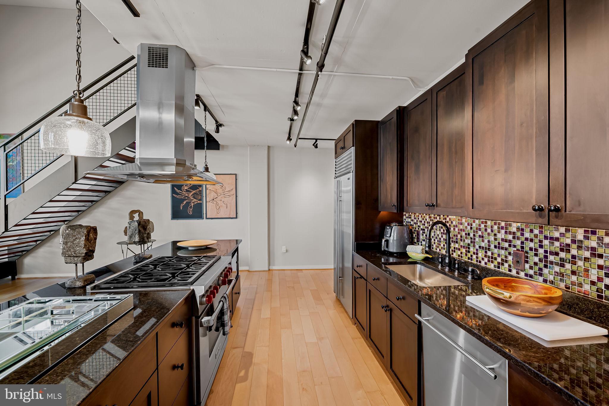 1220 Bank Street, Unit 407 Baltimore, MD 21202 - Photo 20 of 52 a kitchen with a stove and a refrigerator