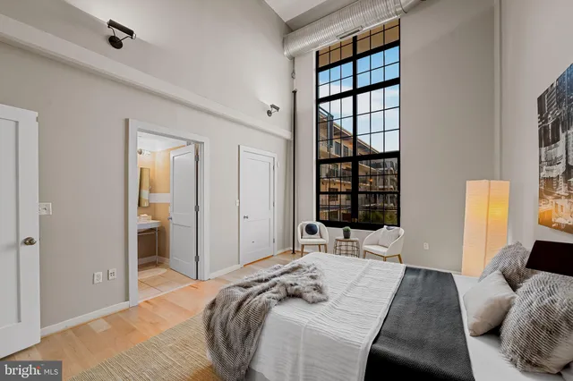 a bedroom with a bed and a window