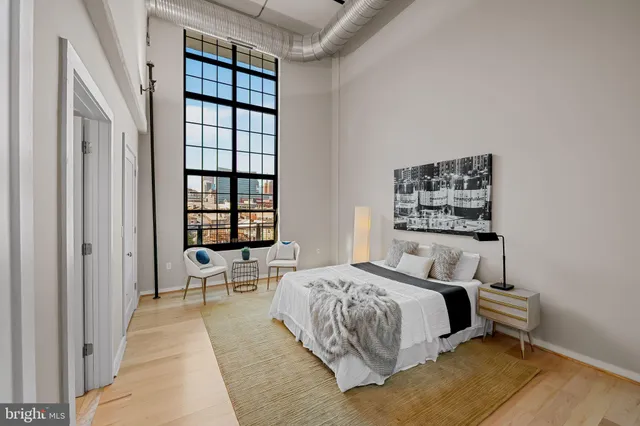 a bedroom with a bed and a window