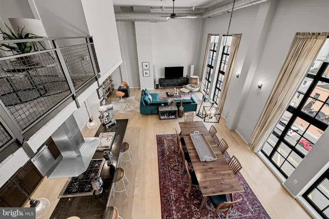 a spacious bedroom with a bed couch and a window