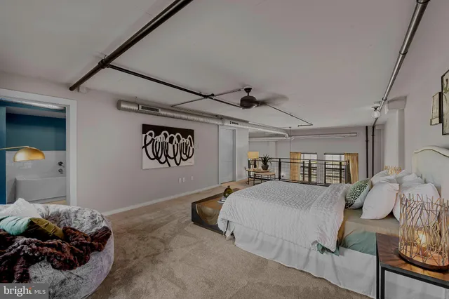 a bedroom with furniture and a large window