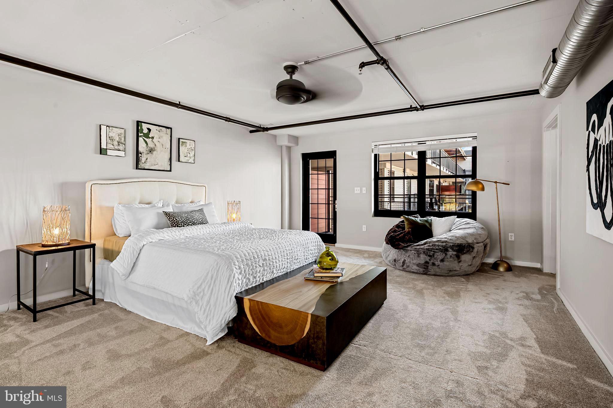 1220 Bank Street, Unit 407 Baltimore, MD 21202 - Photo 32 of 52 a bedroom with furniture and a large window