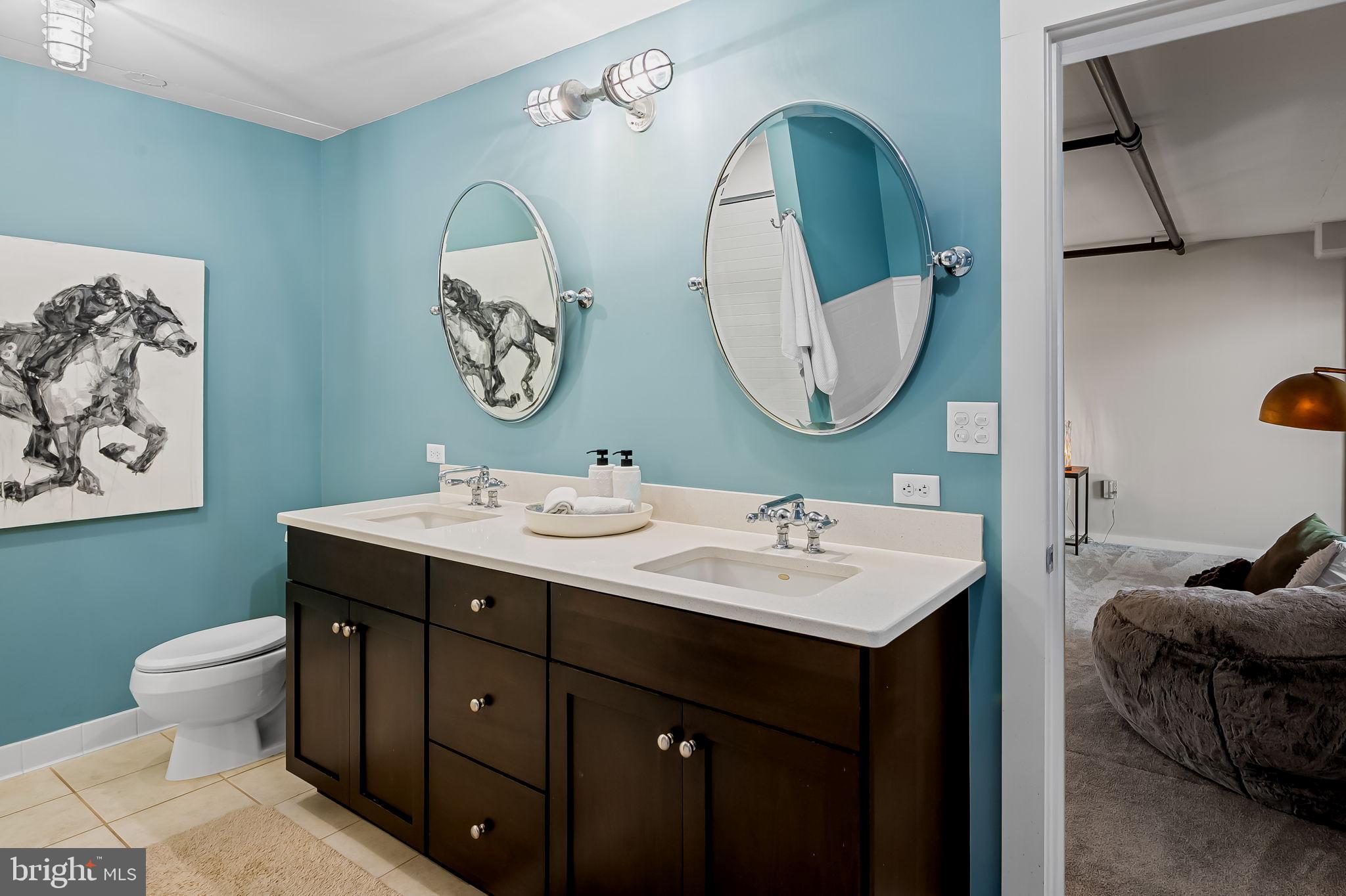 1220 Bank Street, Unit 407 Baltimore, MD 21202 - Photo 34 of 52 a bathroom with a toilet sink and mirror