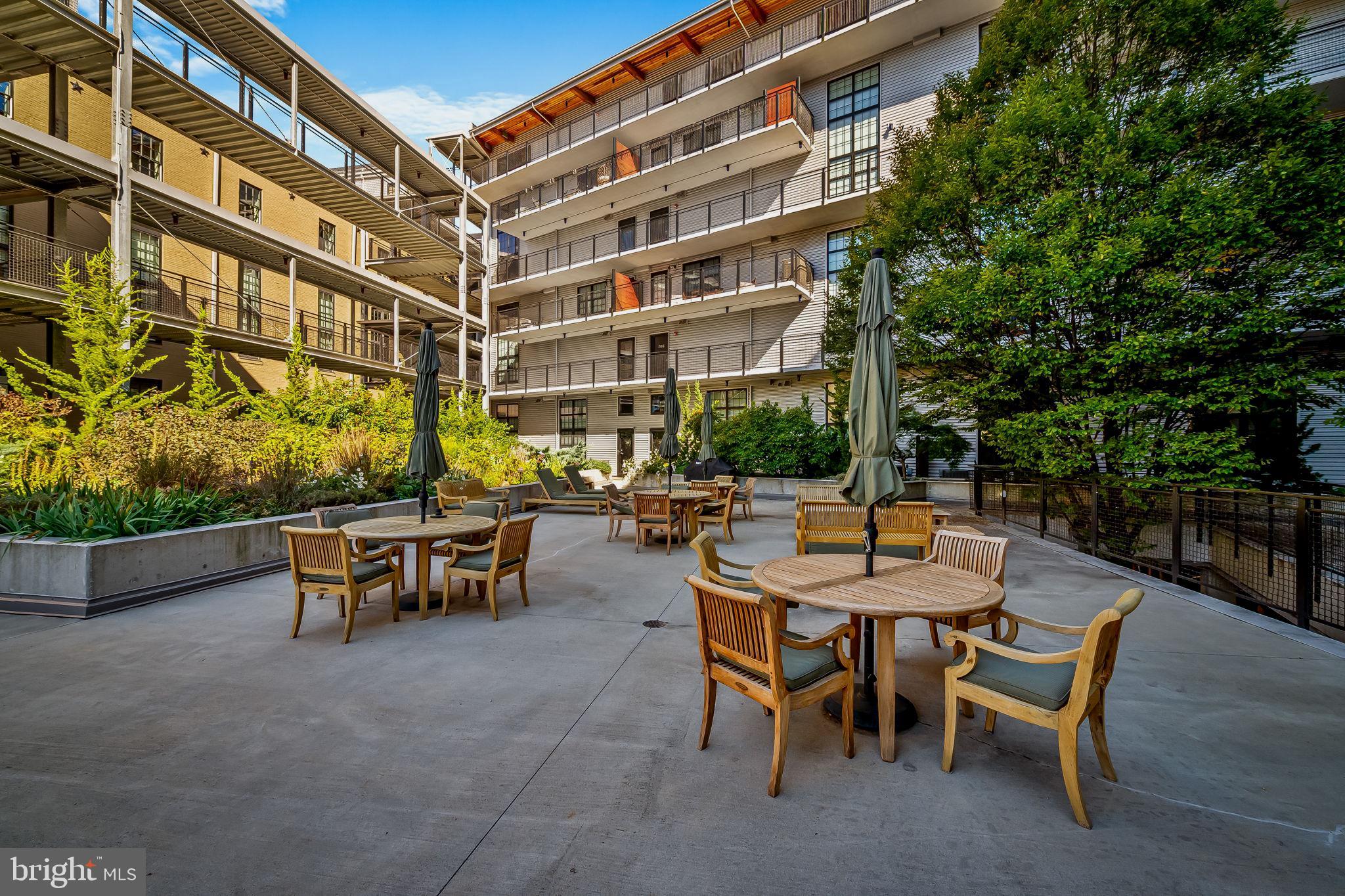 1220 Bank Street, Unit 407 Baltimore, MD 21202 - Photo 44 of 52 a view of a patio with a table and chairs in patio