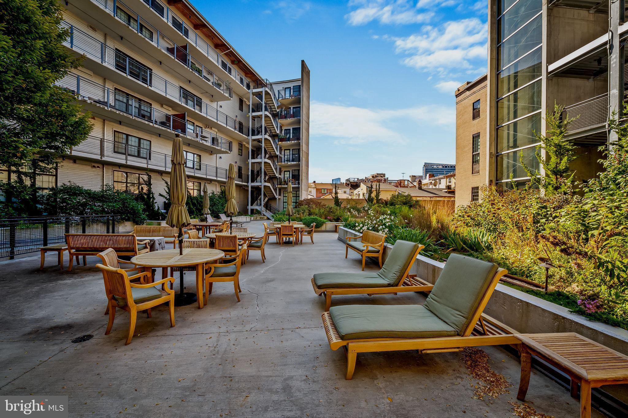 1220 Bank Street, Unit 407 Baltimore, MD 21202 - Photo 47 of 52 a view of a patio with a table and chairs