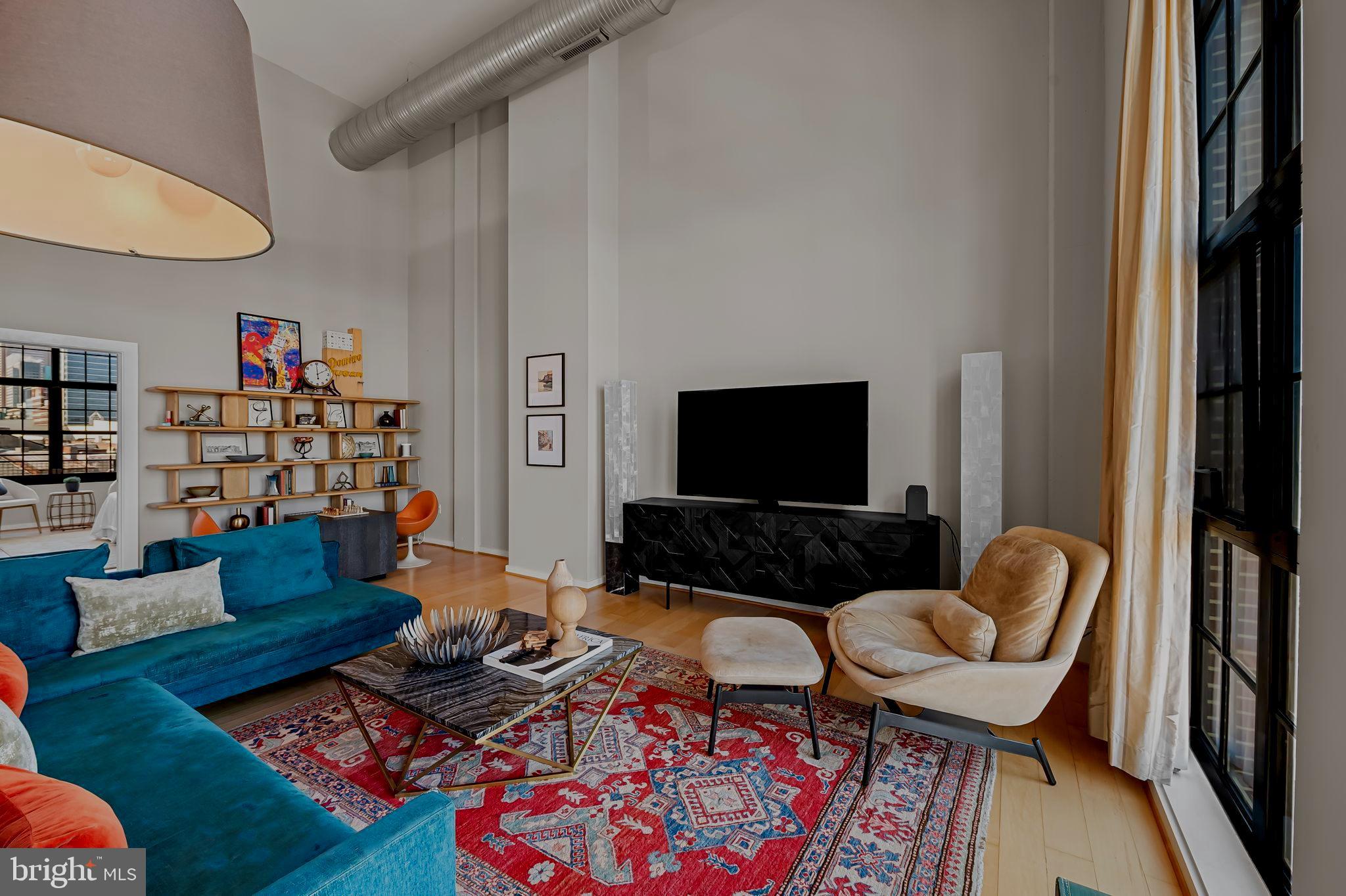 1220 Bank Street, Unit 407 Baltimore, MD 21202 - Photo 9 of 52 a living room with furniture and a flat screen tv