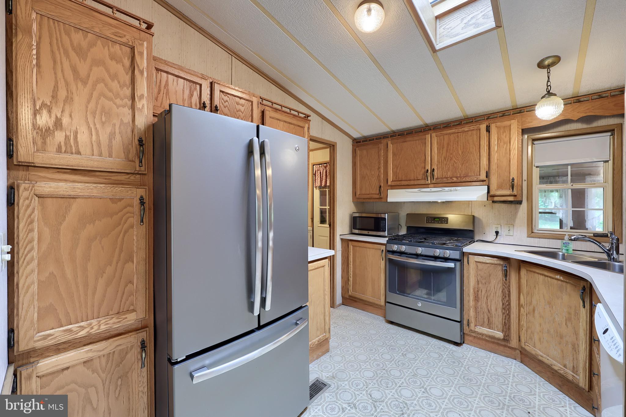 109 Maple Avenue Manheim, PA 17545 - Photo 12 of 39 a kitchen with granite countertop stainless steel appliances a refrigerator a stove and cabinets