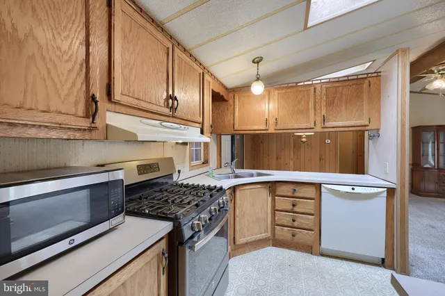 a kitchen with stainless steel appliances granite countertop a stove and a refrigerator
