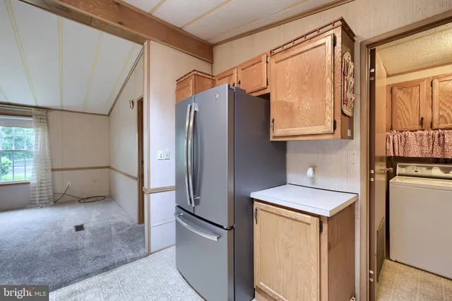 a kitchen with stainless steel appliances a refrigerator sink and cabinets