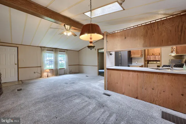 a view of a kitchen with a sink and chandelier fan