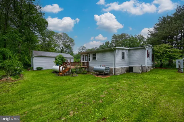 a view of a backyard with plants and a garden