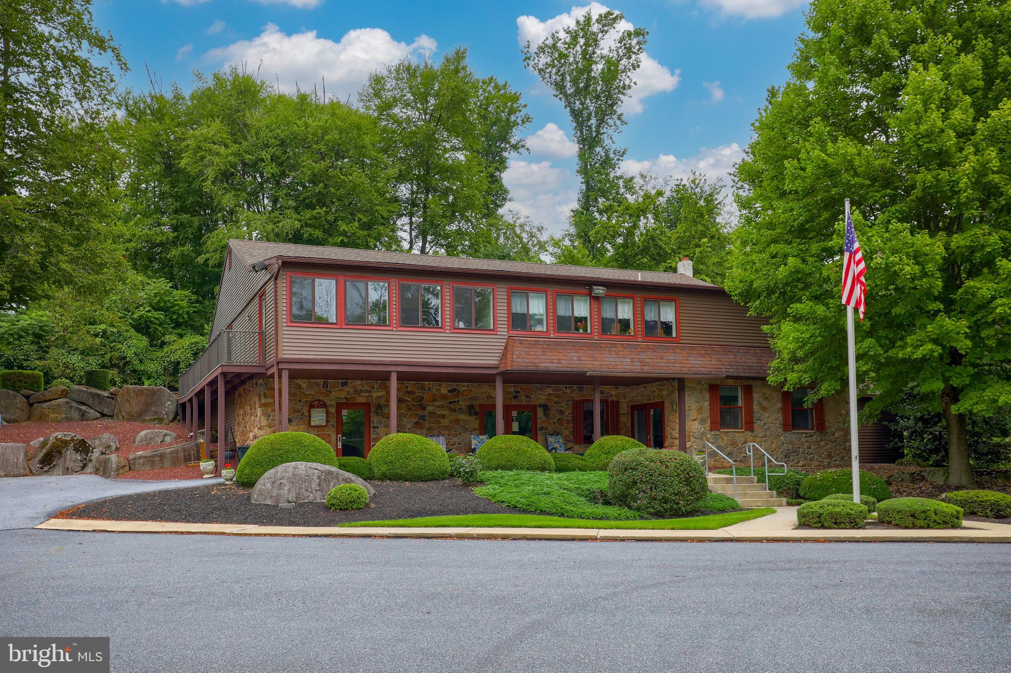 109 Maple Avenue Manheim, PA 17545 - Photo 36 of 39 a view of a brick house with a yard plants and large trees