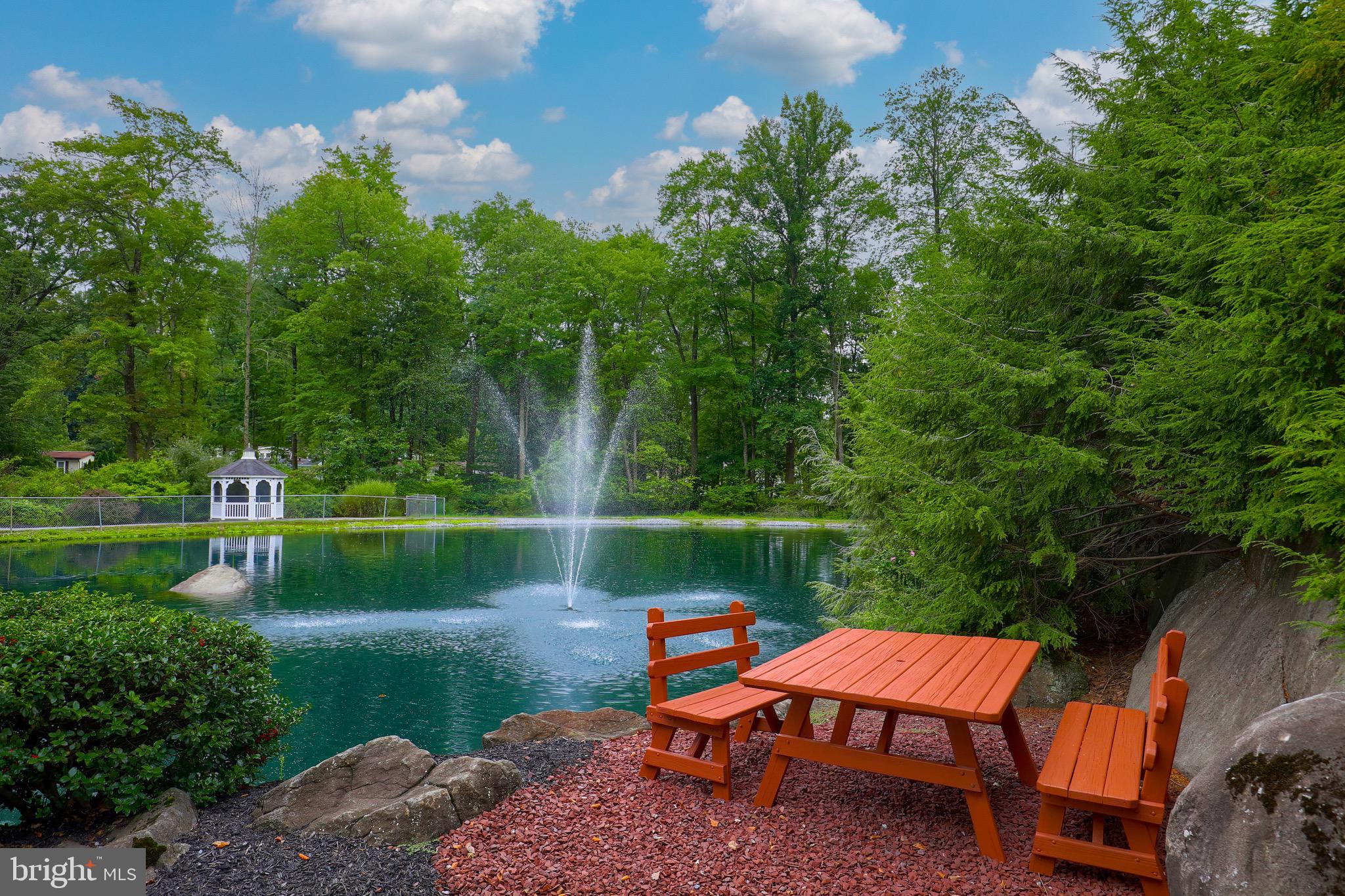 109 Maple Avenue Manheim, PA 17545 - Photo 39 of 39 a wooden bench sitting next to a lake