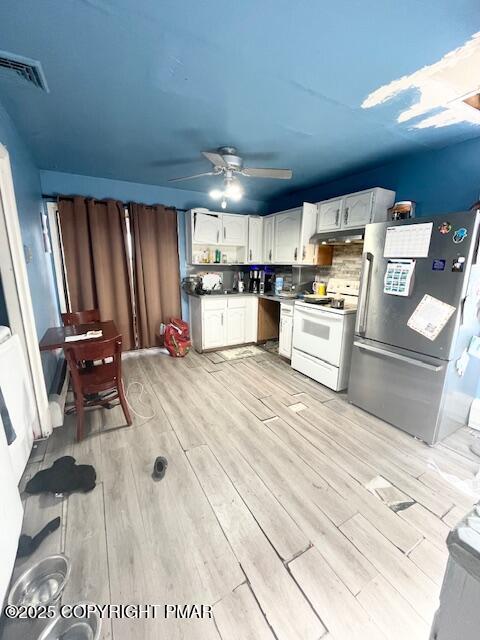 139 Mountain Top Circle Bushkill, PA 18324 - Photo 9 of 21 a large white kitchen with wooden floors and stainless steel appliances