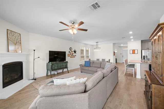 a living room with furniture a fireplace and a flat screen tv