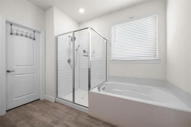 a bathroom with a bathtub and a shower