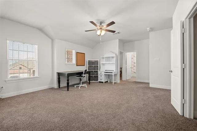 a view of a livingroom with furniture and a ceiling fan