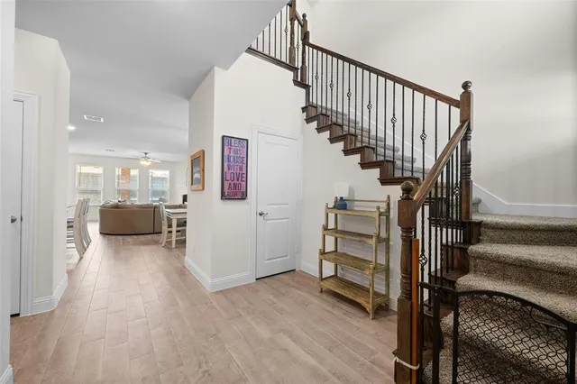 a view of entryway and hall with wooden floor