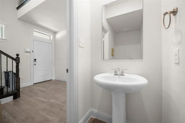 a bathroom with a sink a mirror and a bathtub