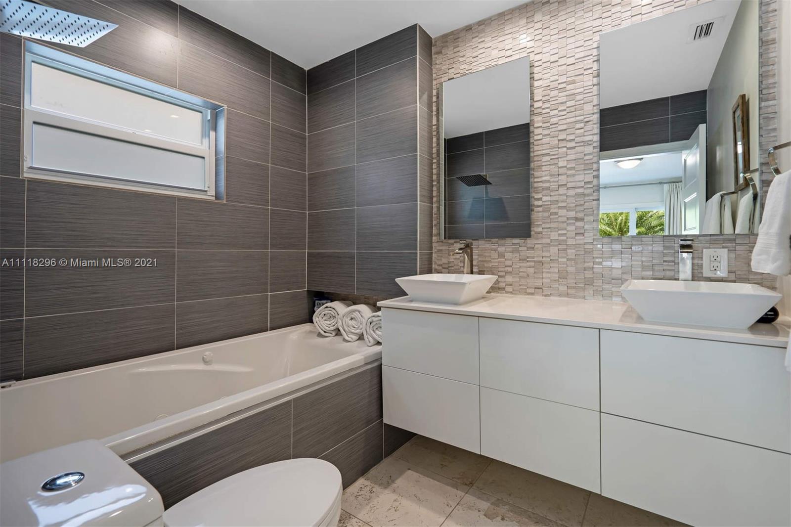 1690 Cleveland Road Miami Beach, FL 33141 - Photo 11 of 29 a bathroom with a sink a toilet and bathtub