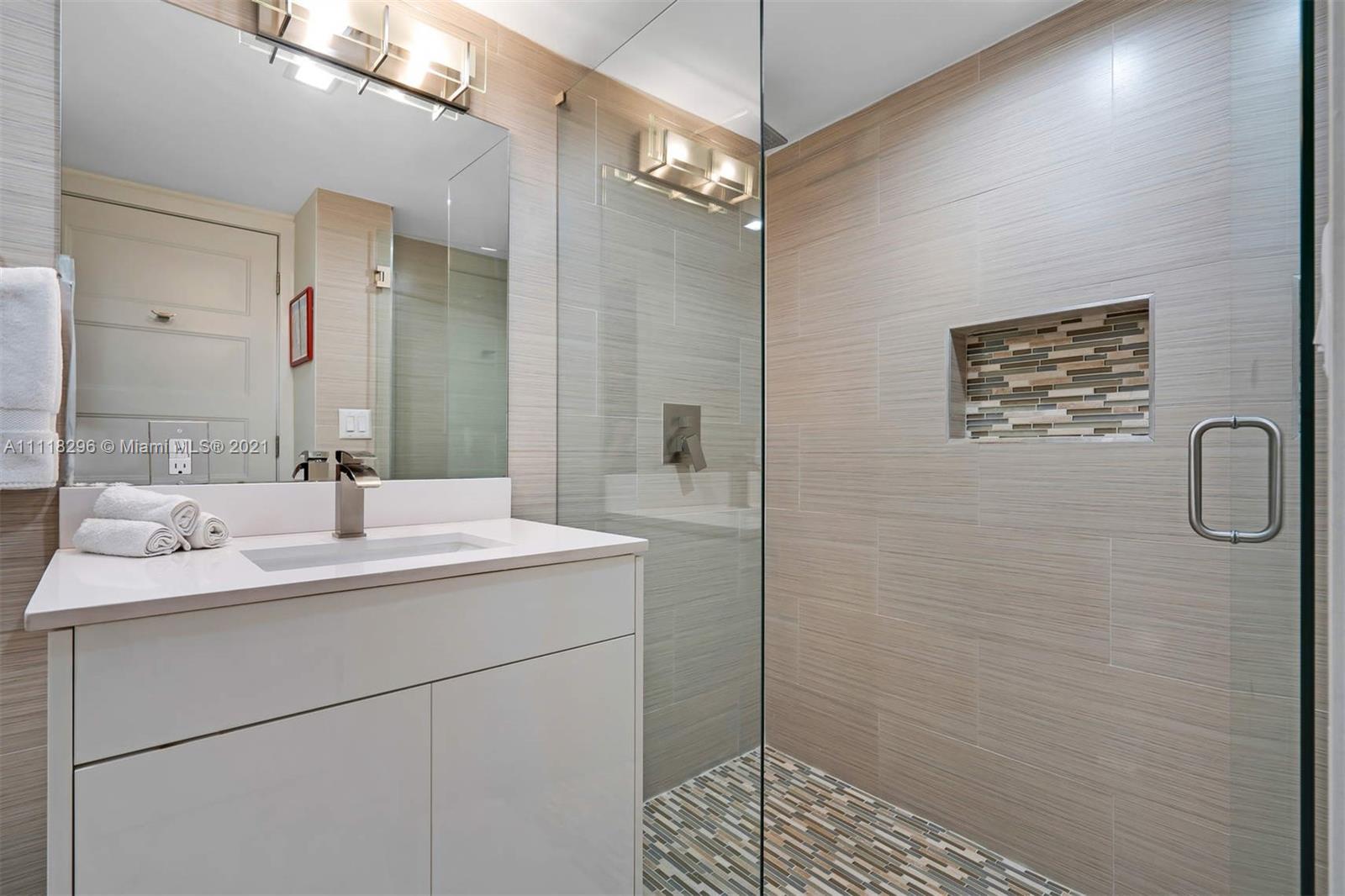 1690 Cleveland Road Miami Beach, FL 33141 - Photo 21 of 29 a bathroom with a sink and a mirror