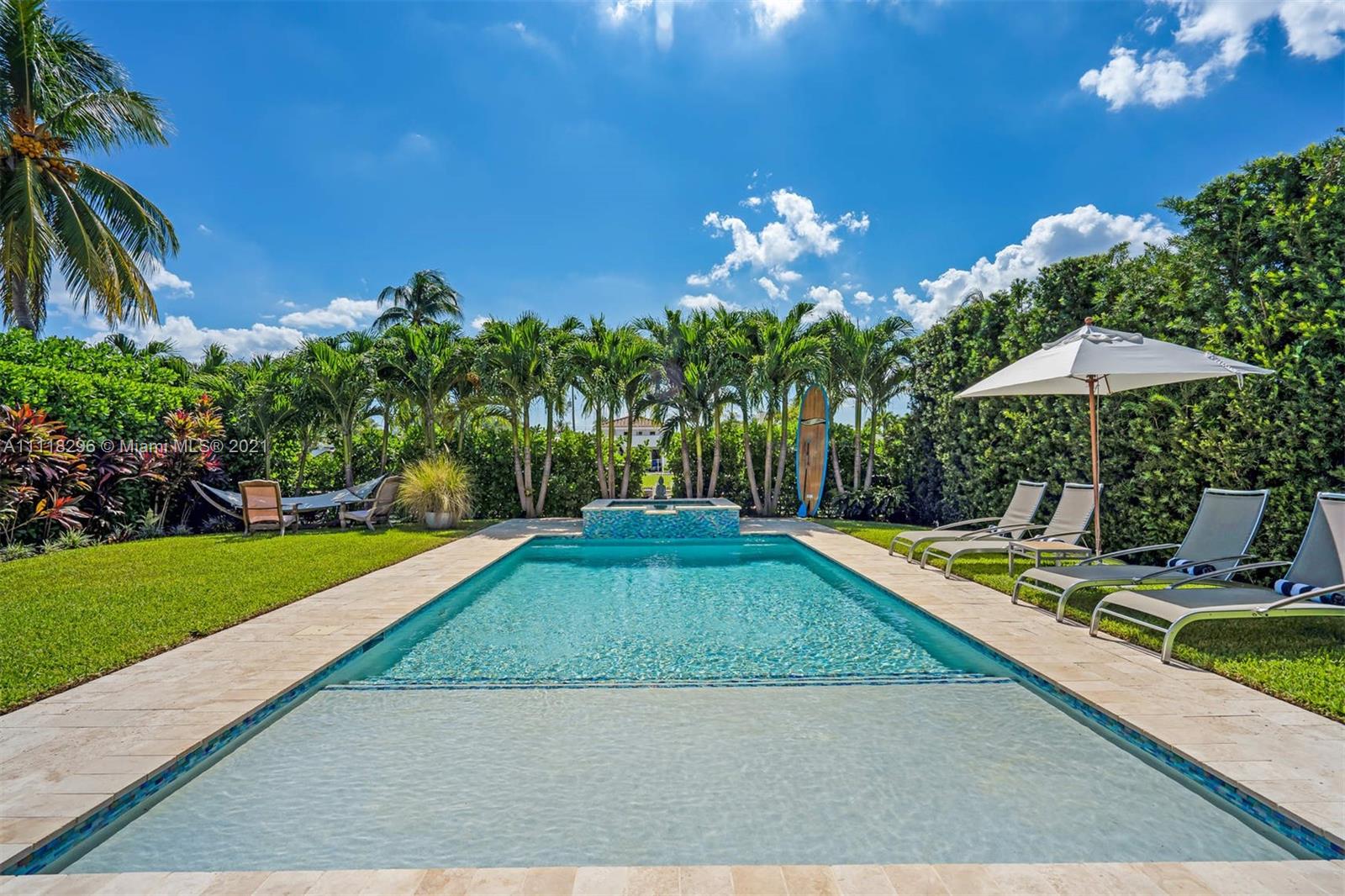1690 Cleveland Road Miami Beach, FL 33141 - Photo 4 of 29 a view of a backyard with chairs under an umbrella