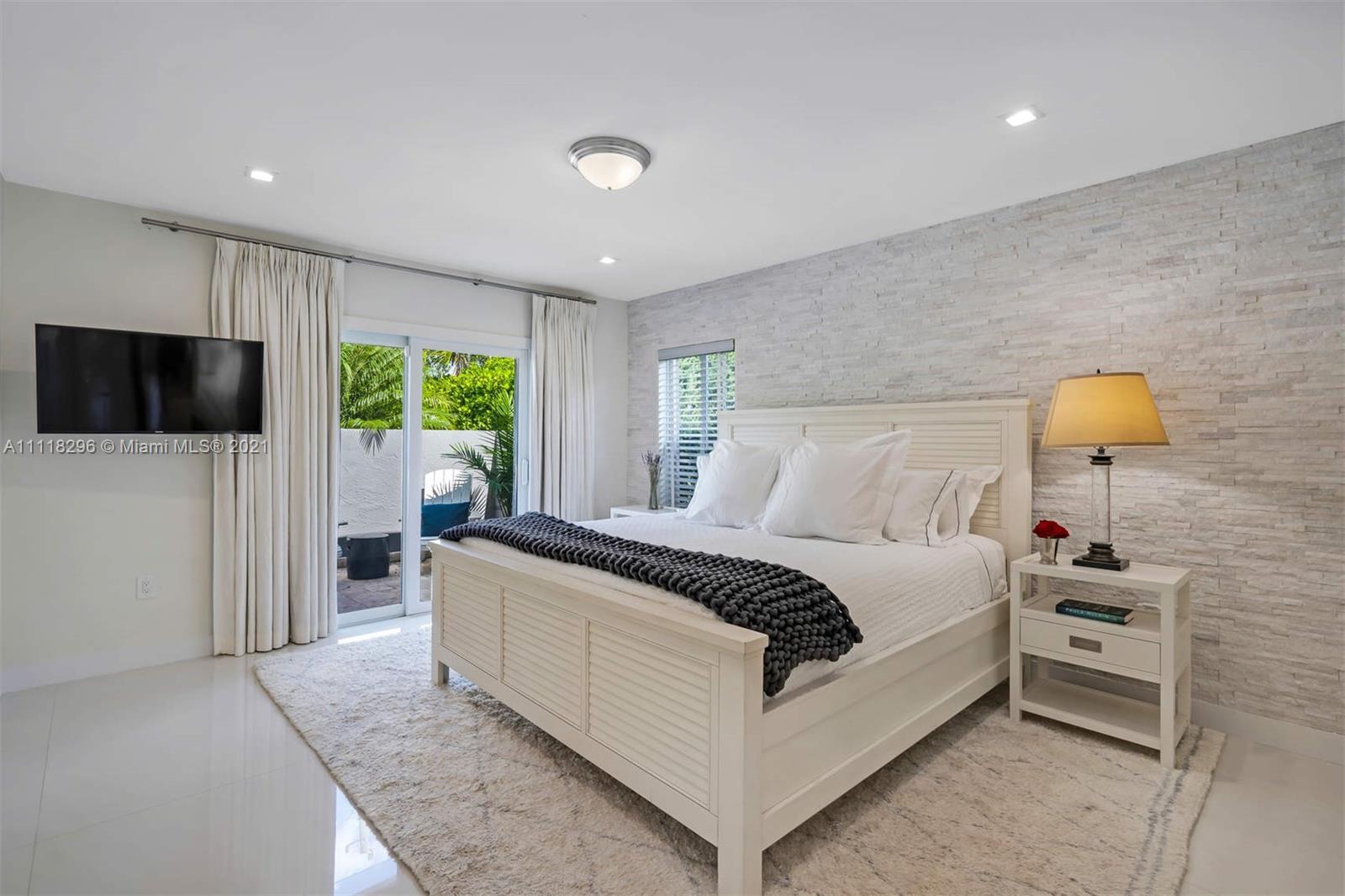 1690 Cleveland Road Miami Beach, FL 33141 - Photo 10 of 29 a bedroom with a bed and a television